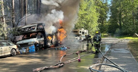 Firefighters battle a fire in an RV in the late afternoon of July 10. (Vashon Island Fire Rescue photo.)
