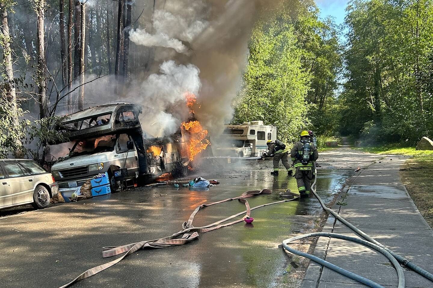 Firefighters battle a fire in an RV in the late afternoon of July 10. (Vashon Island Fire Rescue photo.)