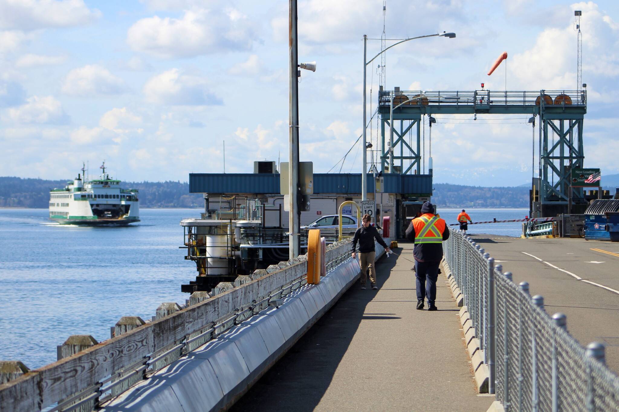 A ferry pulls toward the Fauntleroy ferry dock on a cloud-pocked March afternoon. (Alex Bruell photo.)