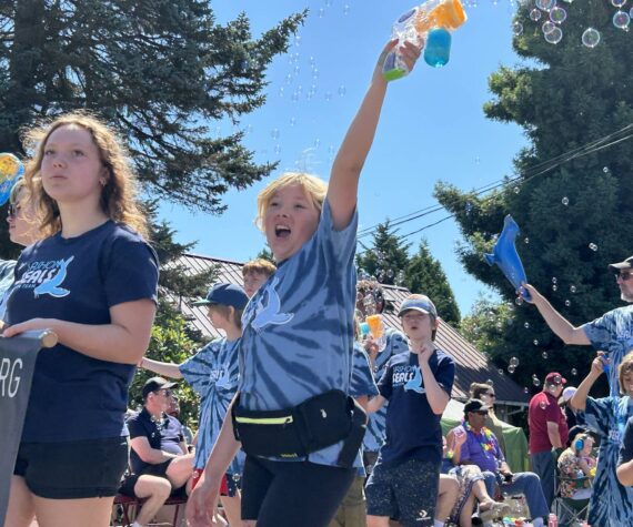 <p>Vashon Seals, surrounded by soap bubbles, exuberantly marched down Vashon Highway during the parade. (Tom Hughes photo)</p>