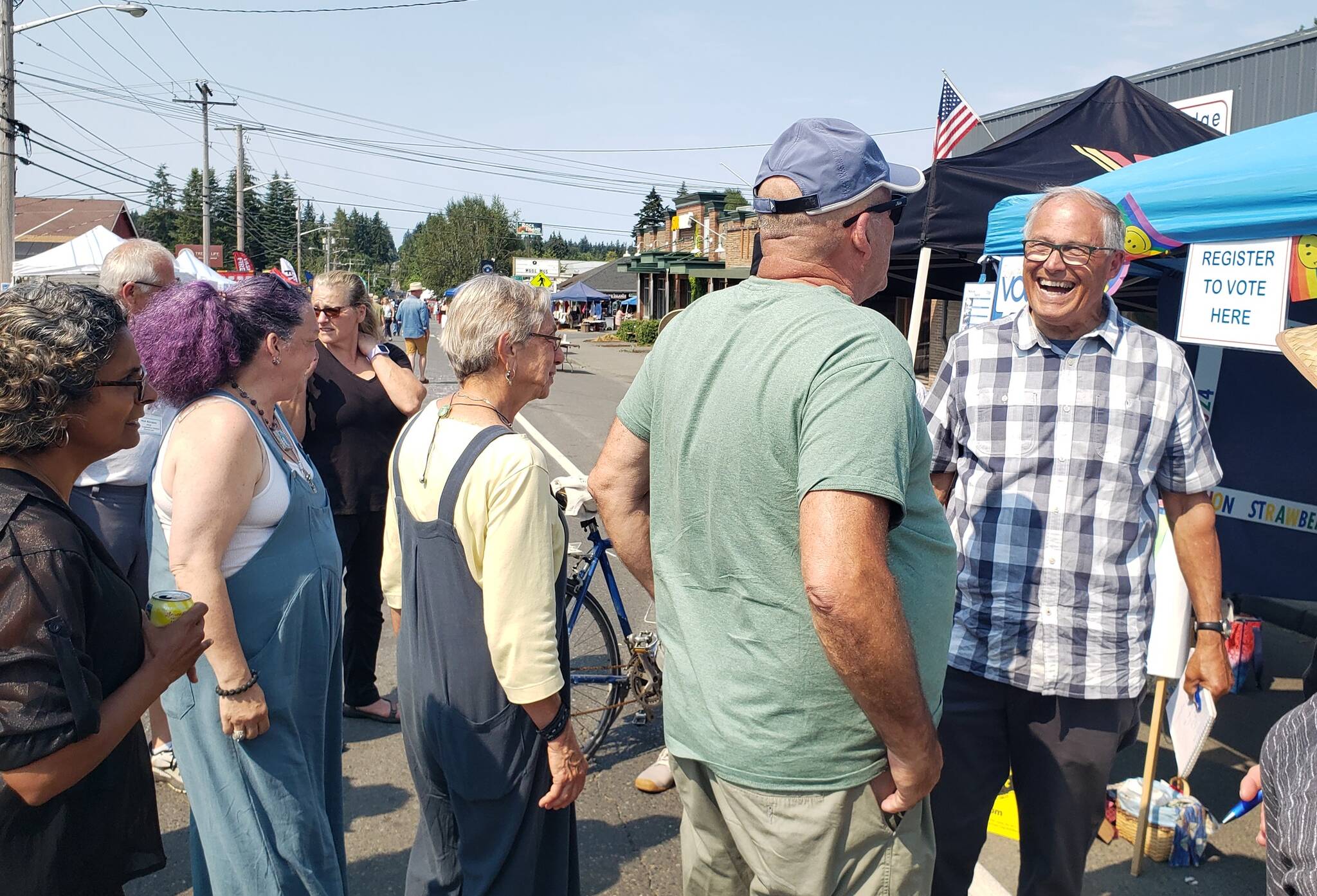 Washington state Governor Jay Inslee mingles with islanders at Strawberry Festival on July 21, 2024. (Leslie Brown photo)