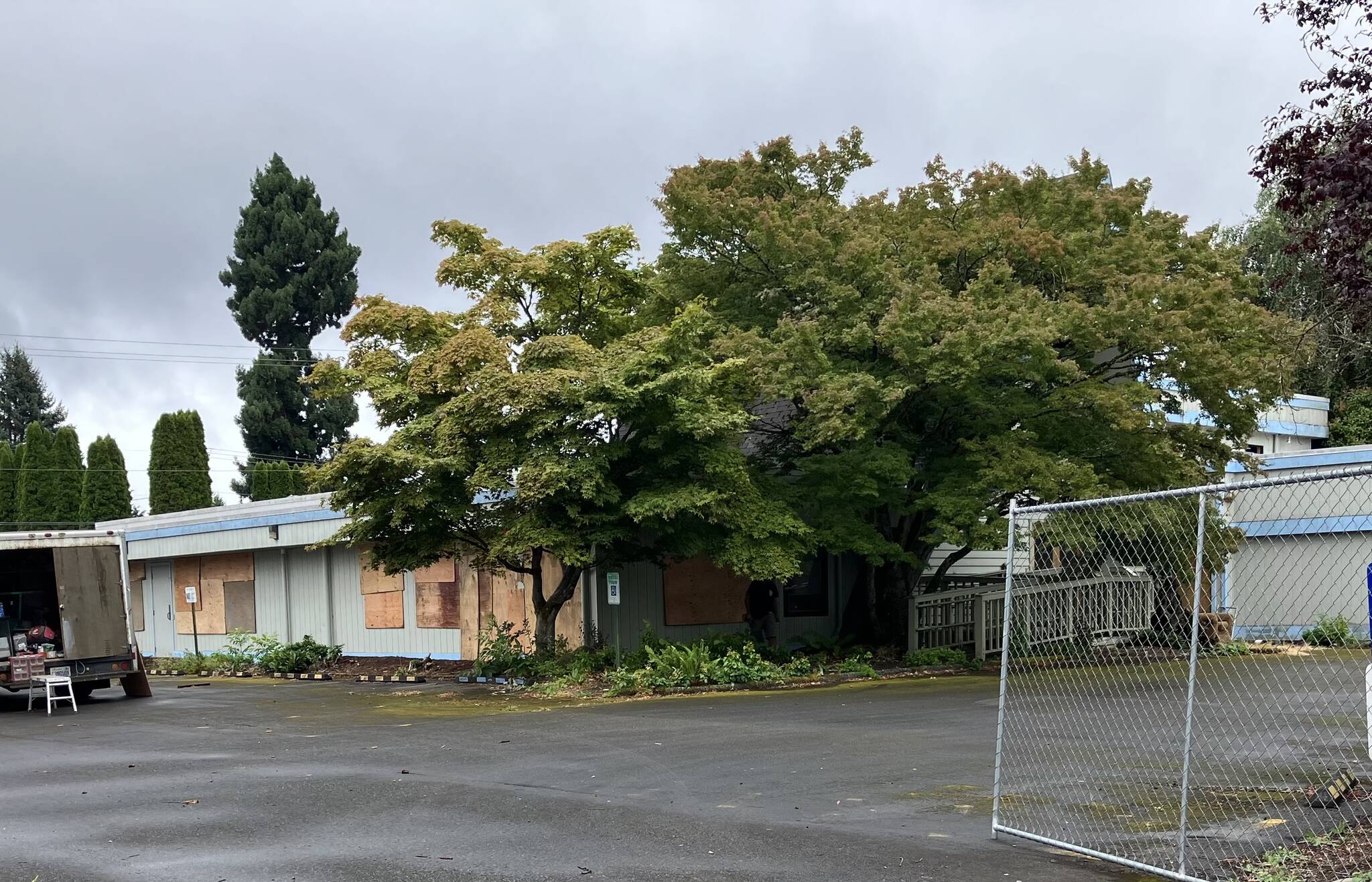 On Monday, a worker contracted by Sea Mar boarded up doors and windows of the Spinnaker building, which had broken and breached by vandals in recent weeks. Some other windows in the building had previously been boarded up. (Elizabeth Shepherd photo)