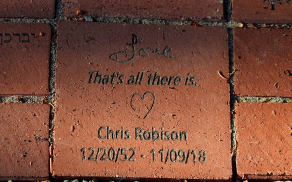 A brick at the Vashon Havurah's new memory garden reads: "Love / That's all there is." in remembrance of Chris Robison. (Alex Bruell photo)
