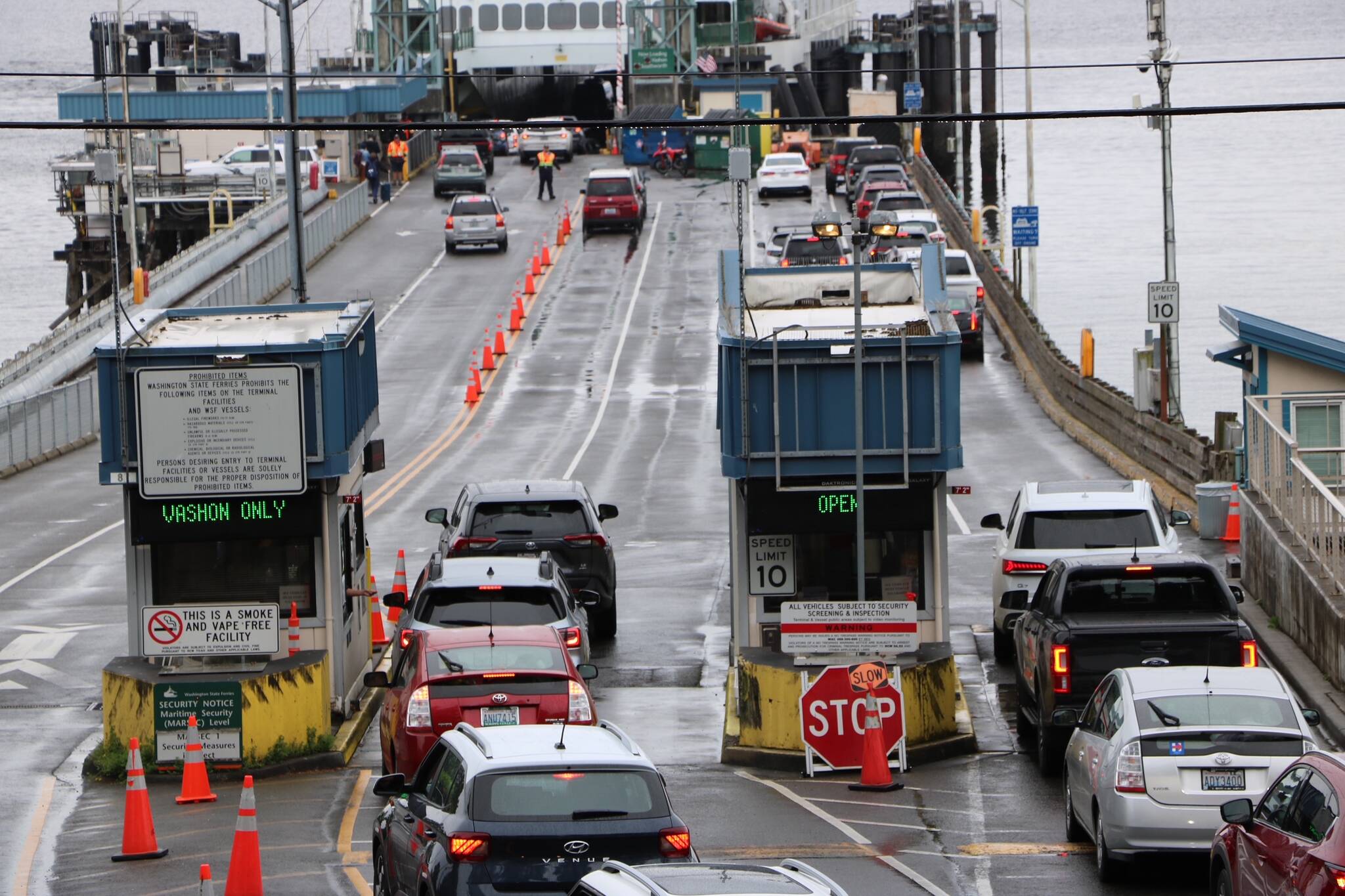 Cars board the Vashon-bound ferry at Fauntleroy as gloomy showers mark the start of Memorial Day weekend on Friday, May 24. (Christina Wardwell photo.)