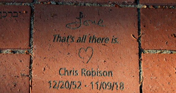 A brick at the Vashon Havurah's new memory garden reads: "Love / That's all there is." in remembrance of Chris Robison. (Alex Bruell photo)