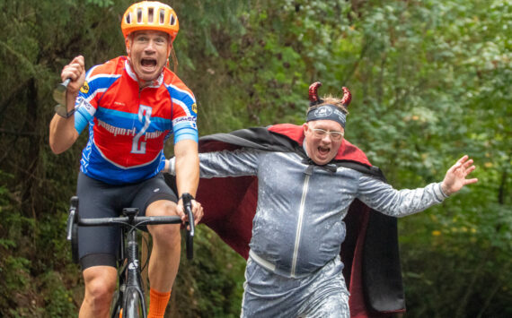 Jim Marsh "encourages" a rider during the Passport2Pain bike ride on Saturday, September 14.