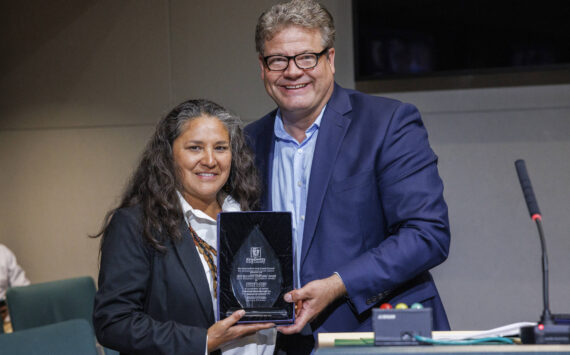 Esther Lucero (Diné), president and CEO of the Seattle Indian Health Board, is presented with the 2024 King County Recovery Champion Award on Sept 24. Councilmember Reagan Dunn presented the award. (Photo by Thomas Hawthorne, King County)