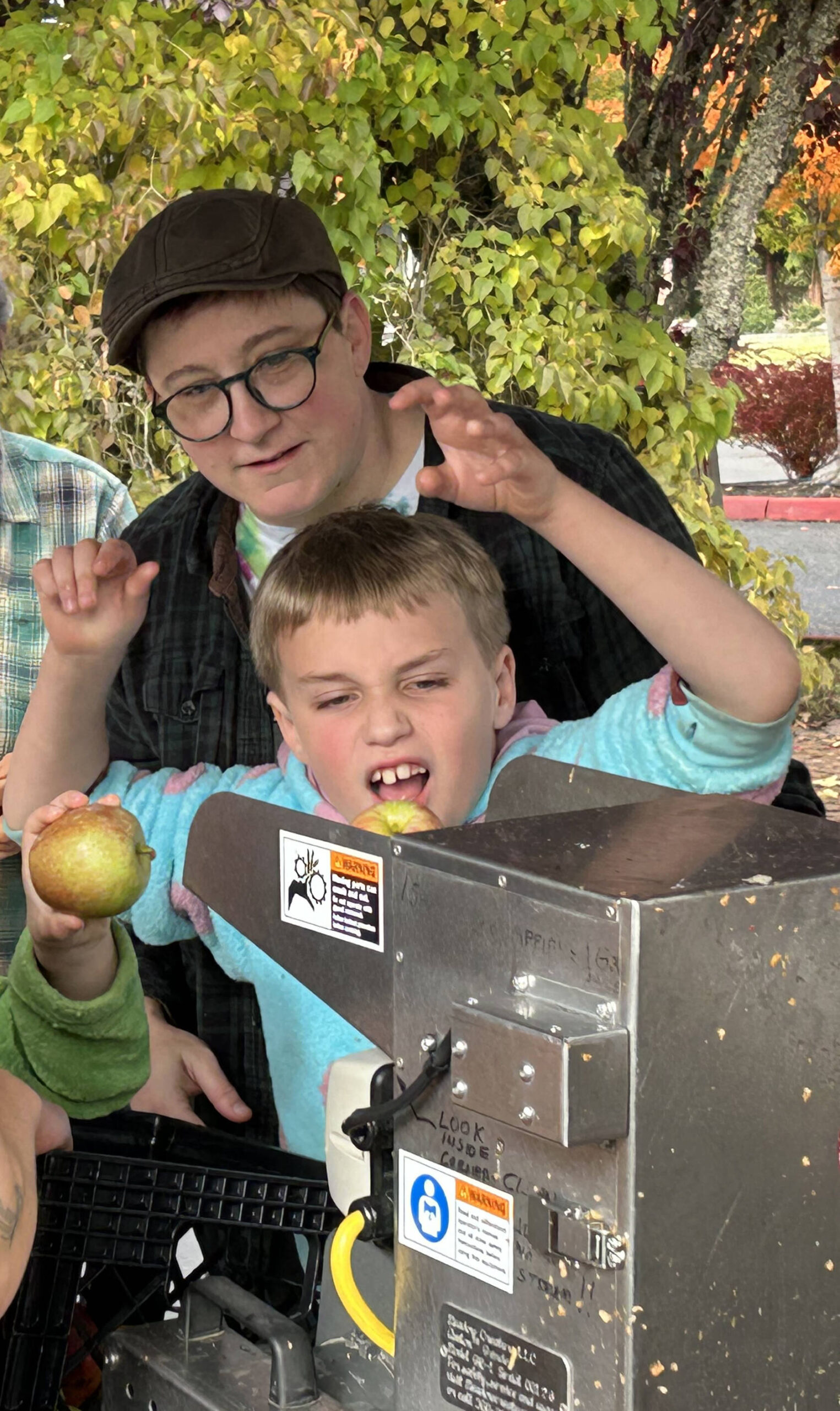 An apple pressing station brought joy to young and old at Cider Fest. (Tom Hughes photo)