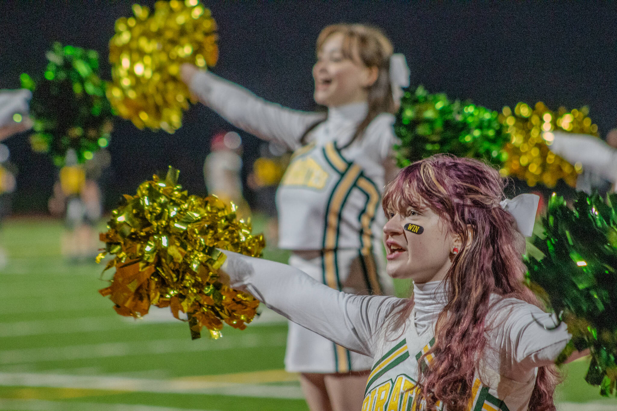 Cheerleaders pump up the crowd. (Alex Bruell photo)