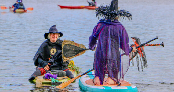 Aspen Anderson photo. Jensen Point transforms into a spectacle of pointed hats and flowing capes as Vashon’s witches take to the water for their annual paddle.