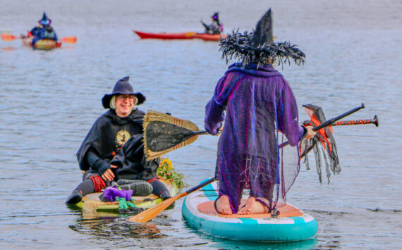 Aspen Anderson photo. Jensen Point transforms into a spectacle of pointed hats and flowing capes as Vashon’s witches take to the water for their annual paddle.