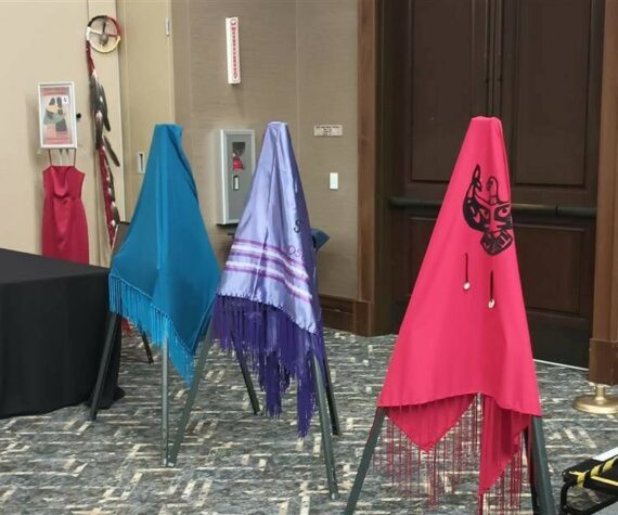 <p>The Lummi Nation provided three colorful shawls during the MMIWP Task Force Summit in September, with turquoise representing human trafficking, purple representing overdoses (“losing our people from fentanyl”) and red representing murdered and missing Indigenous women — all crises that affect North American Natives and Tribes. The summit started with an opening ceremony with words from Lummi Tribal Chair Anthony Hillaire, Lummi Indian Business Council Secretary Lisa Wilson and a Shawl Ceremony with Lhaq’temish singers. Photo by Bailey Jo Josie/Sound Publishing</p>