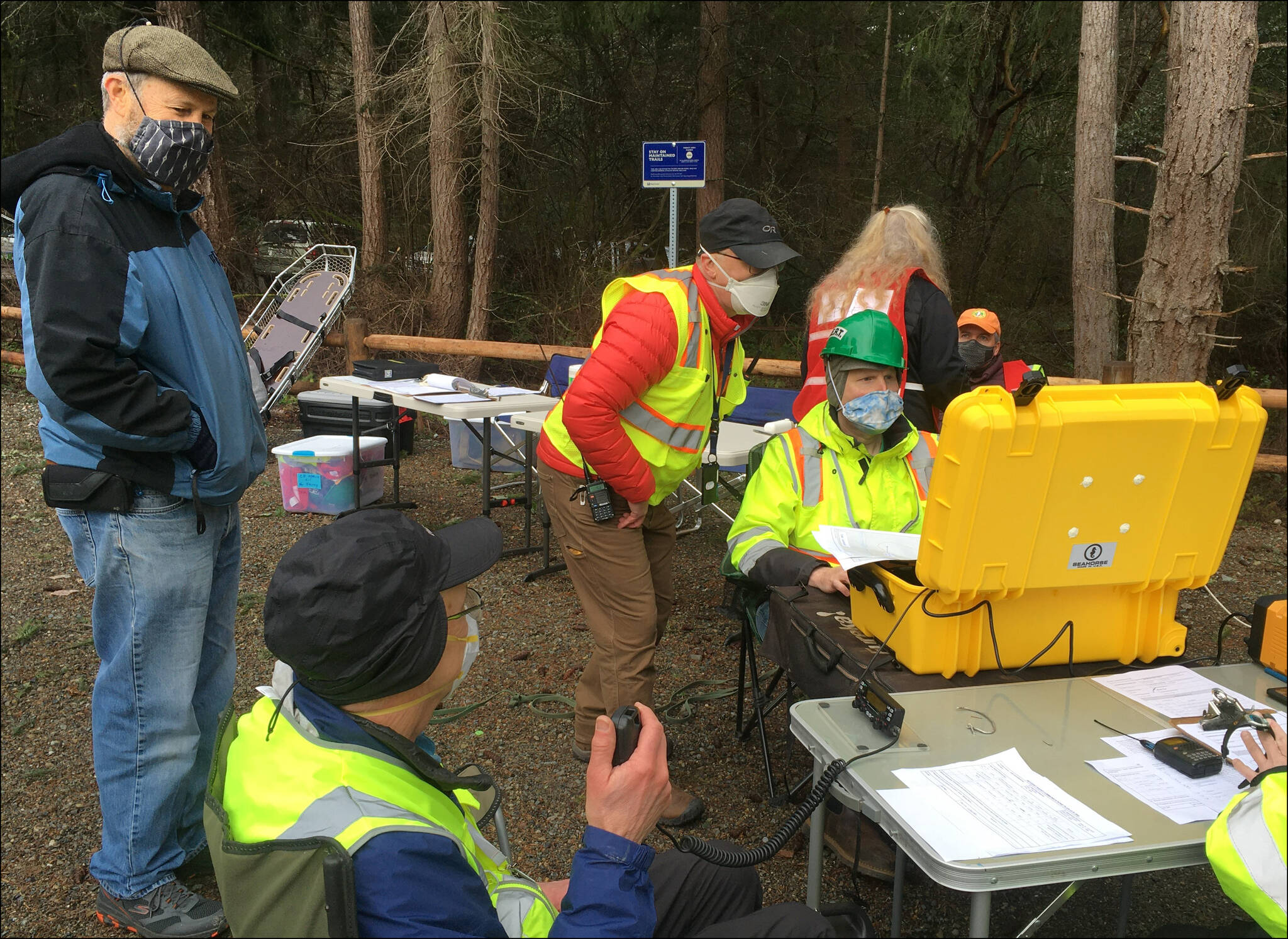 This ham radio team set up to support a command post staffed by members of the Community Emergency Response Team (CERT). They are using one of the group’s portable communications caches (PCCs, in the yellow waterproof case) that has been packed with a range of radio communications capabilities, including email over ham radio using software called Winlink. (Courtesy photo)