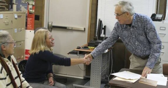 File photo
Elaine Ott-Rocheford shakes John Hopkins' hand after she accepts the park district board's offer to become the new director of the agency in early 2013.