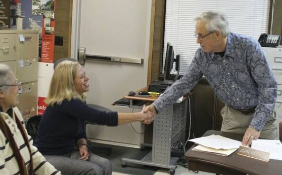 File photo
Elaine Ott-Rocheford shakes John Hopkins' hand after she accepts the park district board's offer to become the new director of the agency in early 2013.