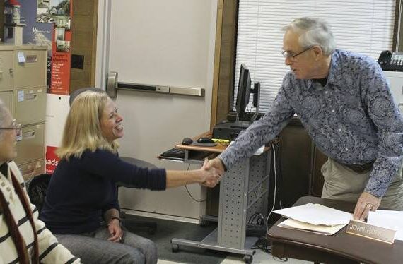 File photo
Elaine Ott-Rocheford shakes John Hopkins' hand after she accepts the park district board's offer to become the new director of the agency in early 2013.