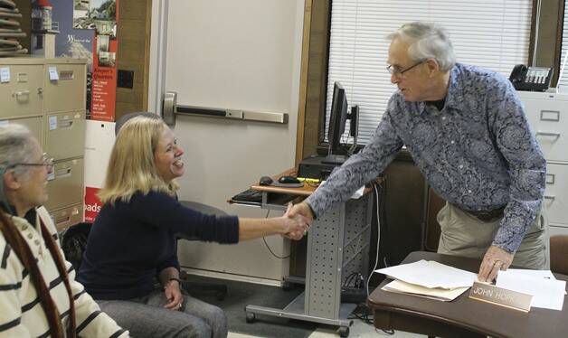 Elaine Ott-Rocheford shakes John Hopkins’ hand after she accepts the park district board’s offer to become the new director of the agency in early 2013. (File photo)