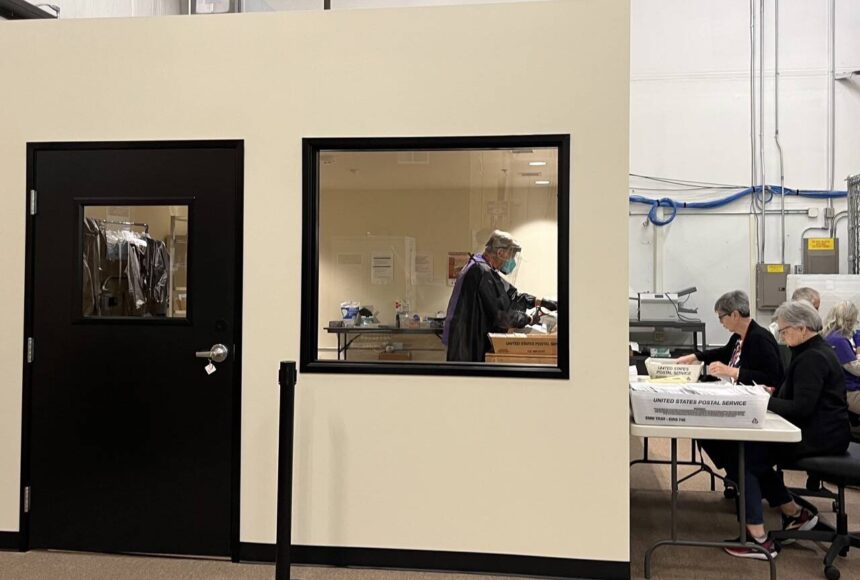 <p>Election workers open mail in a new secure room at Thurston County’s elections office. The county invested in a separate room to open mail after it was sent an envelope containing fentanyl last year. (Laurel Demkovich/Washington State Standard)</p>