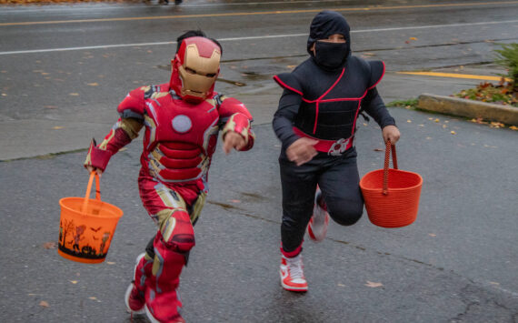 Alex Bruell photo
Kids rush to the Vashon Chamber of Commerce to collect candy on Halloween night.