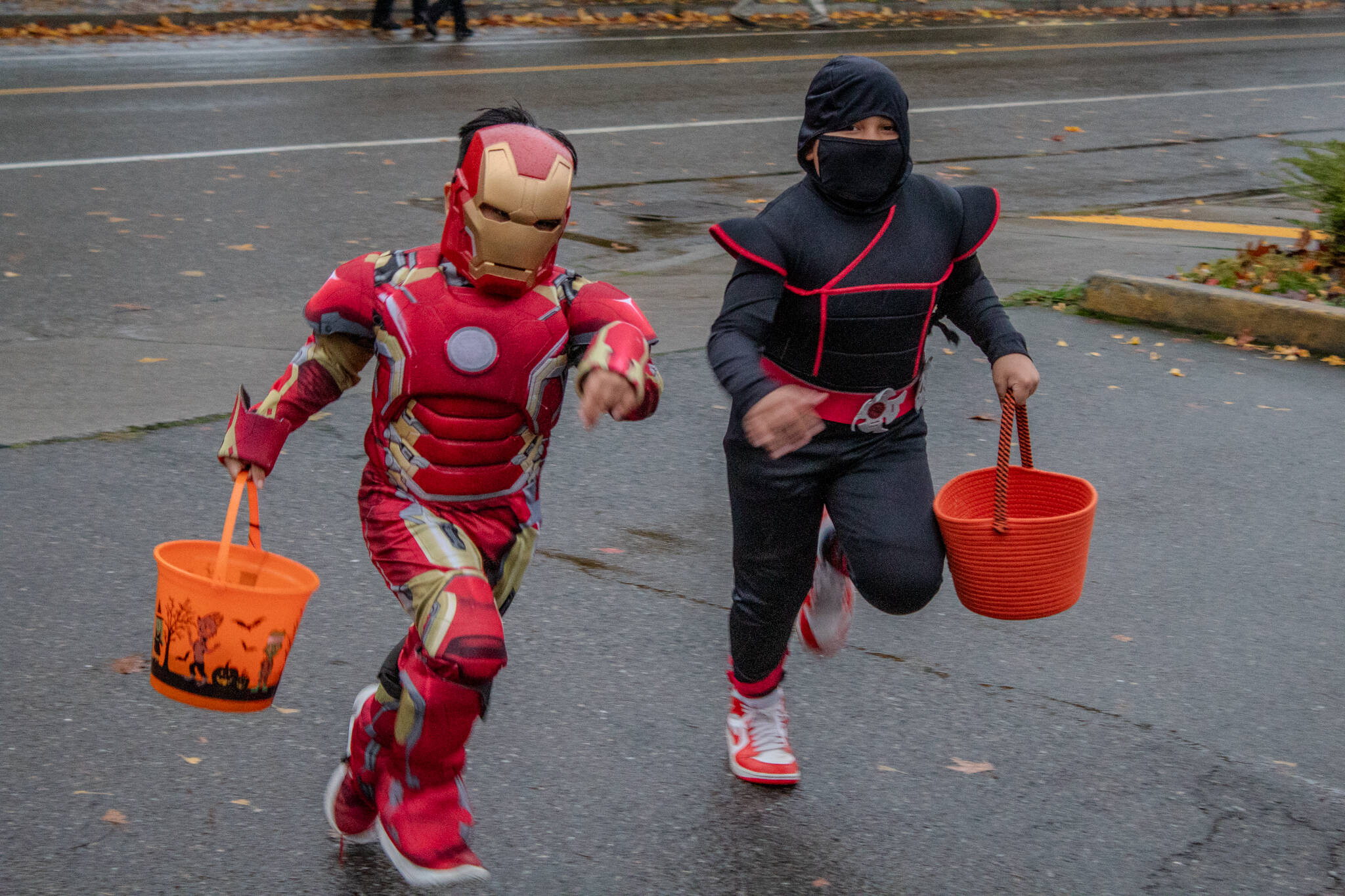 Kids rush to the Vashon Chamber of Commerce to collect candy on Halloween night. (Alex Bruell photo)