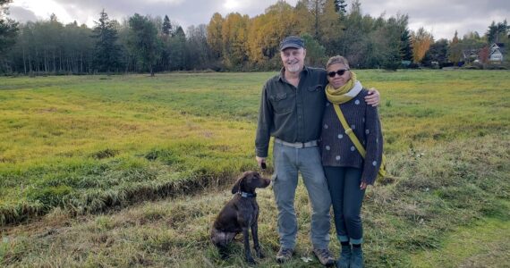 Leslie Brown photo
Morgan Brown, Pia Bloom and their dog Suki stand in front of the field on the south side of S.W. 178th.