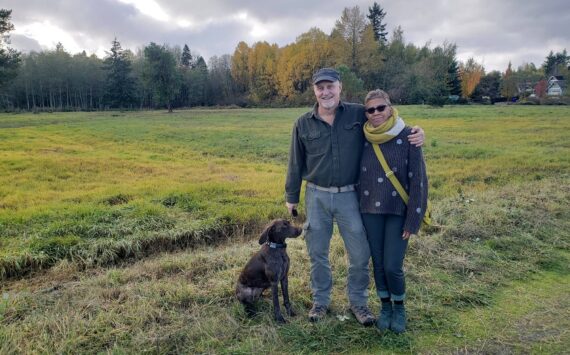 Leslie Brown photo
Morgan Brown, Pia Bloom and their dog Suki stand in front of the field on the south side of S.W. 178th.