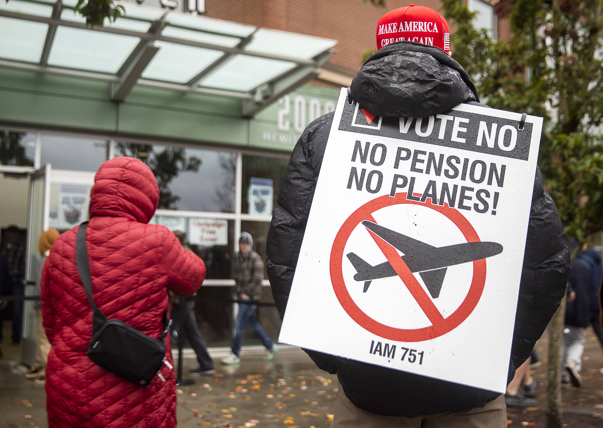 Larry Best, a customer coordinator for quality assurance who has worked at Boeing for 38 years, stands outside of Angel of the Winds Arena with a “vote no” sign on Monday in Everett. (Olivia Vanni / The Herald)