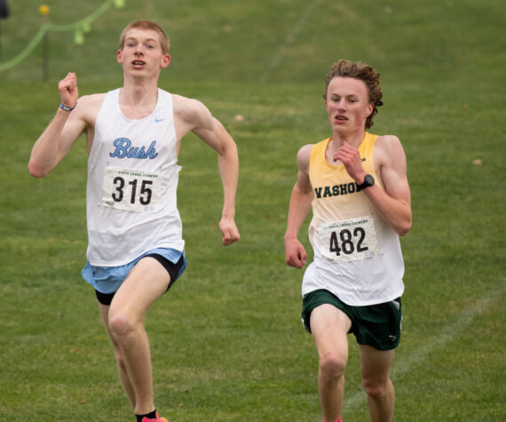 John Decker photo
Duncan Frisbie-Smith of the Bush School slugs it out with Vashon's Josh Healey in a dramatic photo-finish for second place at the Washington State Championships at Sun Willows Golf Course in Pasco, WA on Saturday, November 9, 2024.