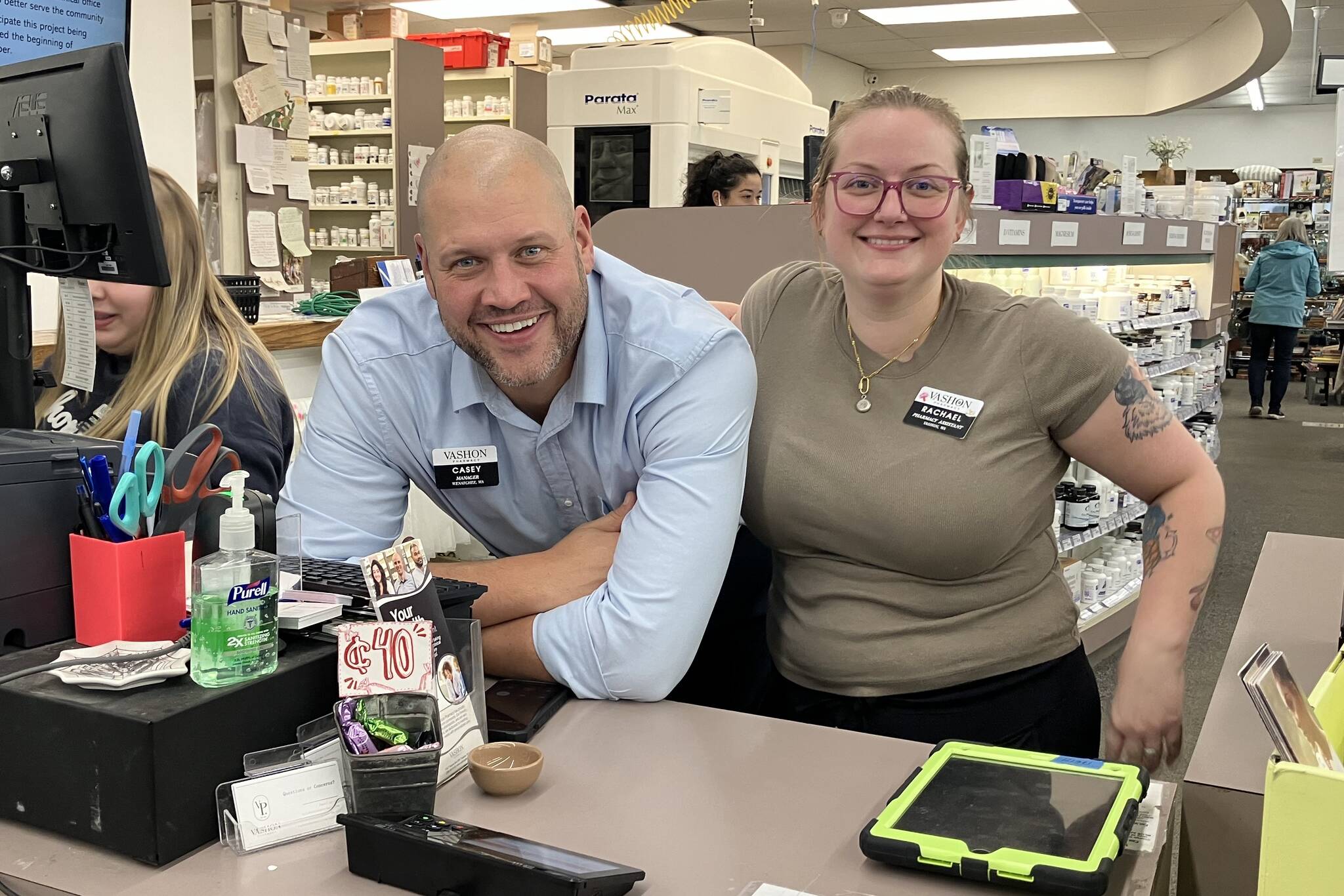 Vashon Pharmacy’s manager, Casey Rose (left), and pharmacy employee Rachael Beck offer up smiles from behind the pharmacy’s counter. (Elizabeth Shepherd photo)