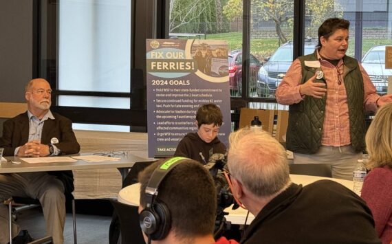 Courtesy photo
Islanders for Ferry Action Director Amy Drayer welcomes participants to the Regional Ferry Summit as Rick Wallace prepares to moderate the first panel discussion. 