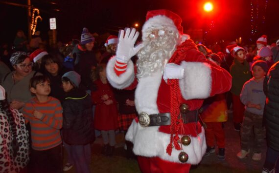 Santa waves to the camera on Vashon Highway SW. Jim Diers photo