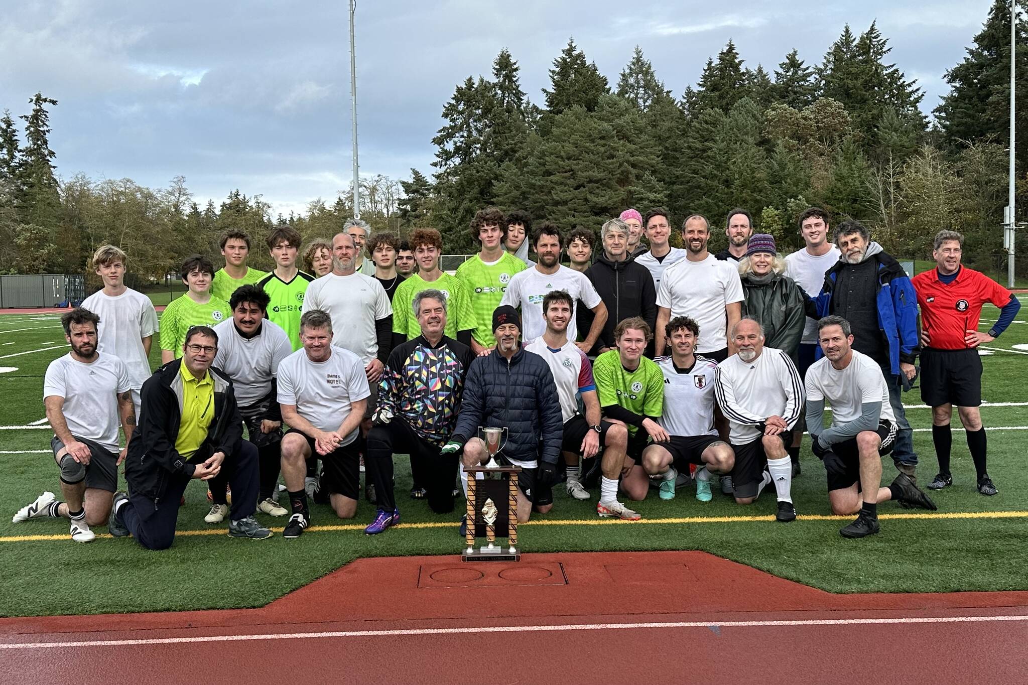 The men and youth of this year’s Ryan Krug Memorial Cup are pictured after the end of the game. (Cara Briskman photo)