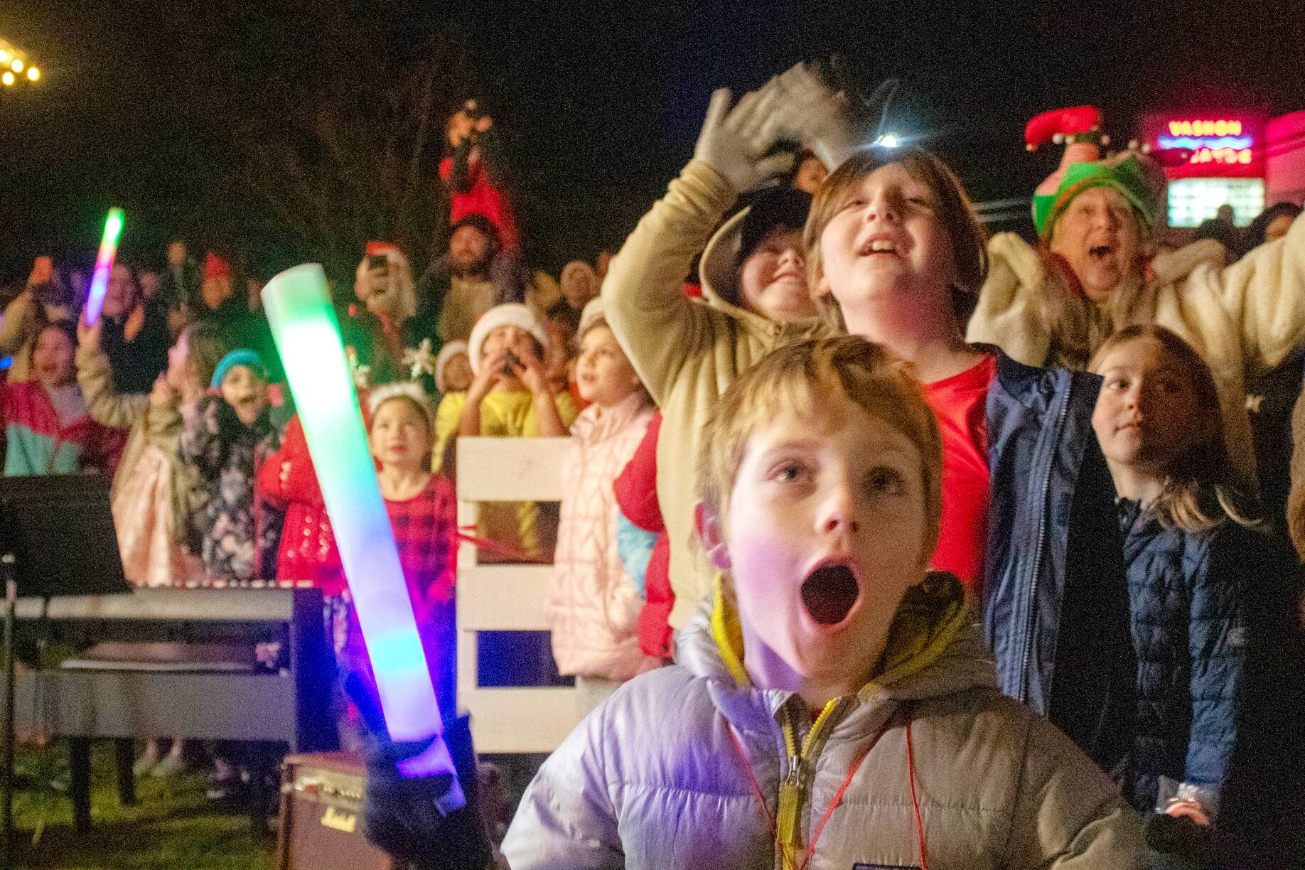 Kids and adults react as the great tree lights up next to the Vashon Presbyterian Church. (Alex Bruell photo)