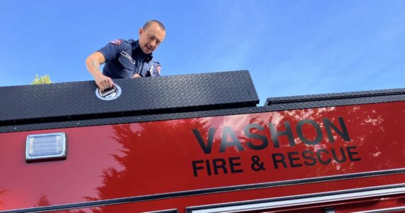 Lieutenant/Acting Captain Brad Johns, atop Vashon Island Fire & Rescue’s new fire truck, in October. (File photo by Elizabeth Shepherd)