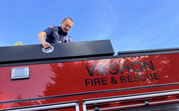 Lieutenant/Acting Captain Brad Johns, atop Vashon Island Fire & Rescue’s new fire truck, in October. (File photo by Elizabeth Shepherd)