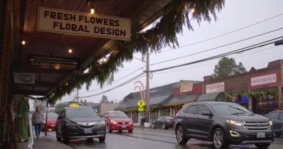 Alex Bruell photo
Cars pass through the busy core of Vashon's Rural Town area, much of which (including the properties visible in this photo) is zoned Community Business. The maximum residential density for Community Business properties has just increased in the King County Comprehensive Plan update. That's among many other changes that come with this month's passage of the plan update, most of which affect places in the Rural Town.