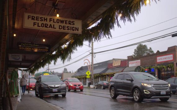 Alex Bruell photo
Cars pass through the busy core of Vashon's Rural Town area, much of which (including the properties visible in this photo) is zoned Community Business. The maximum residential density for Community Business properties has just increased in the King County Comprehensive Plan update. That's among many other changes that come with this month's passage of the plan update, most of which affect places in the Rural Town.