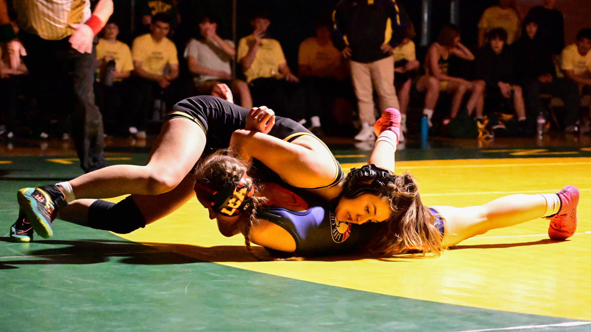 Kyla Scheff works to achieve a fall in a home dual meet. (Tony Puz photo)